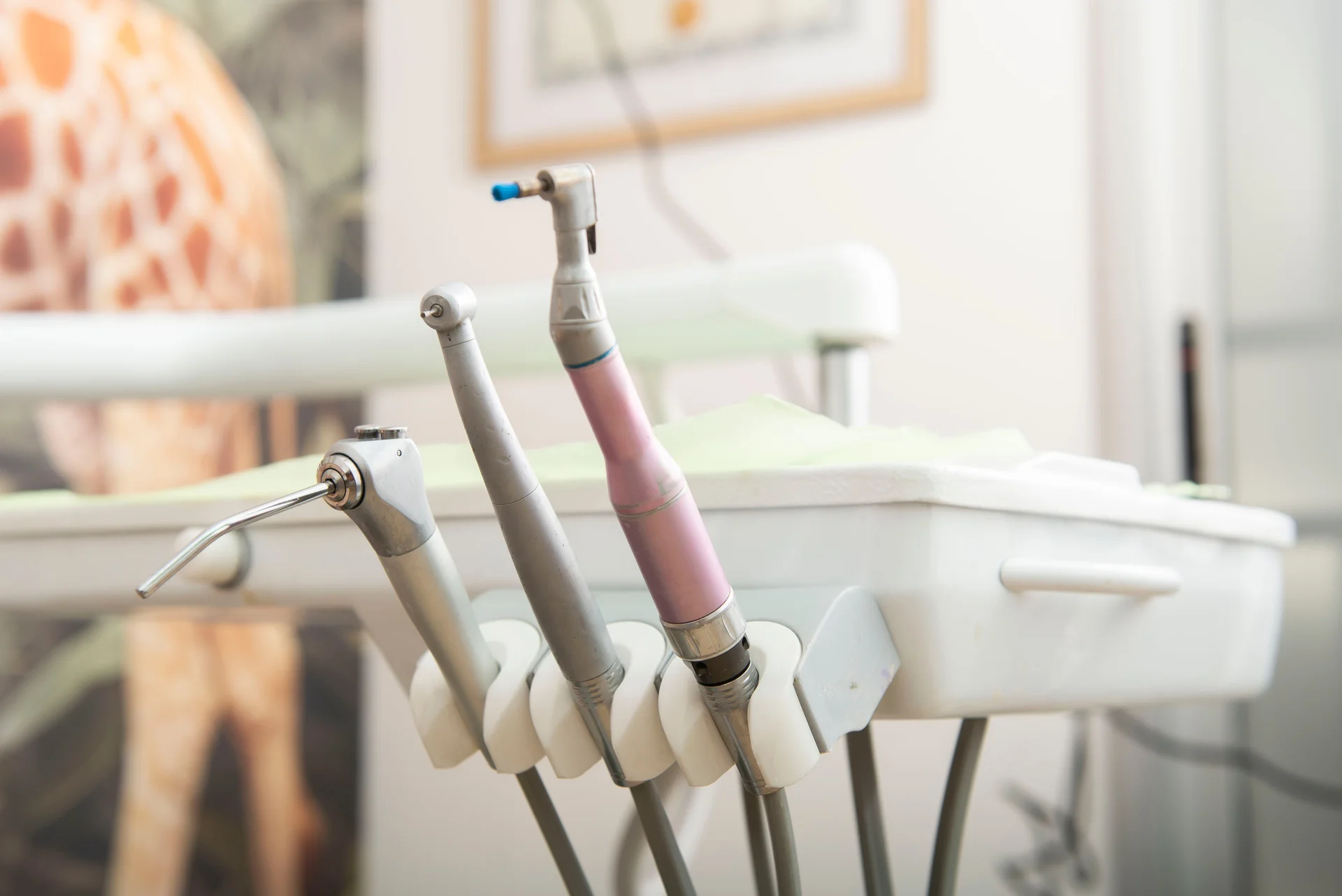 Close-up of modern dental handpieces in a bright, modern operatory