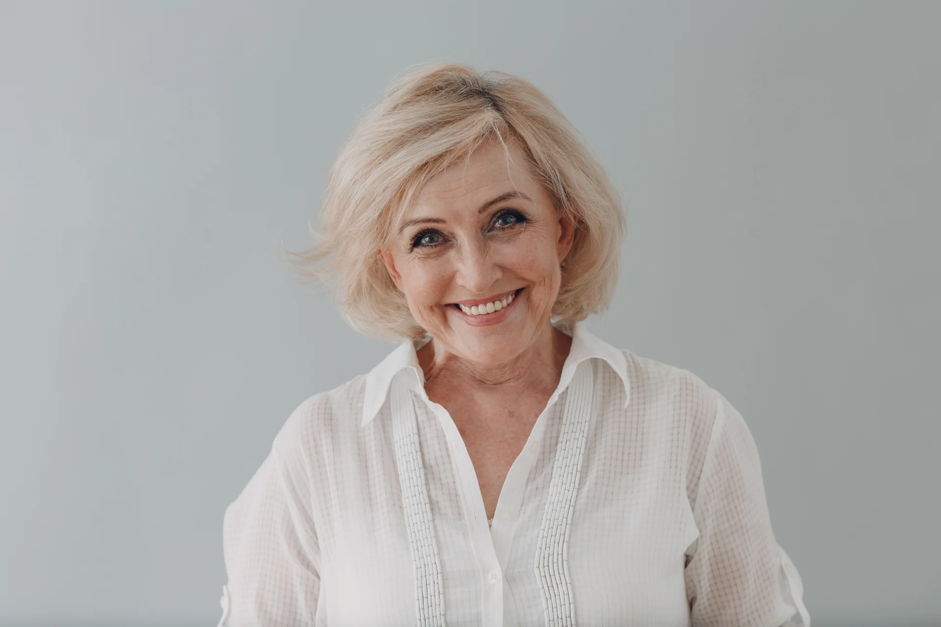 Smiling patient showing natural-looking dental bridge results