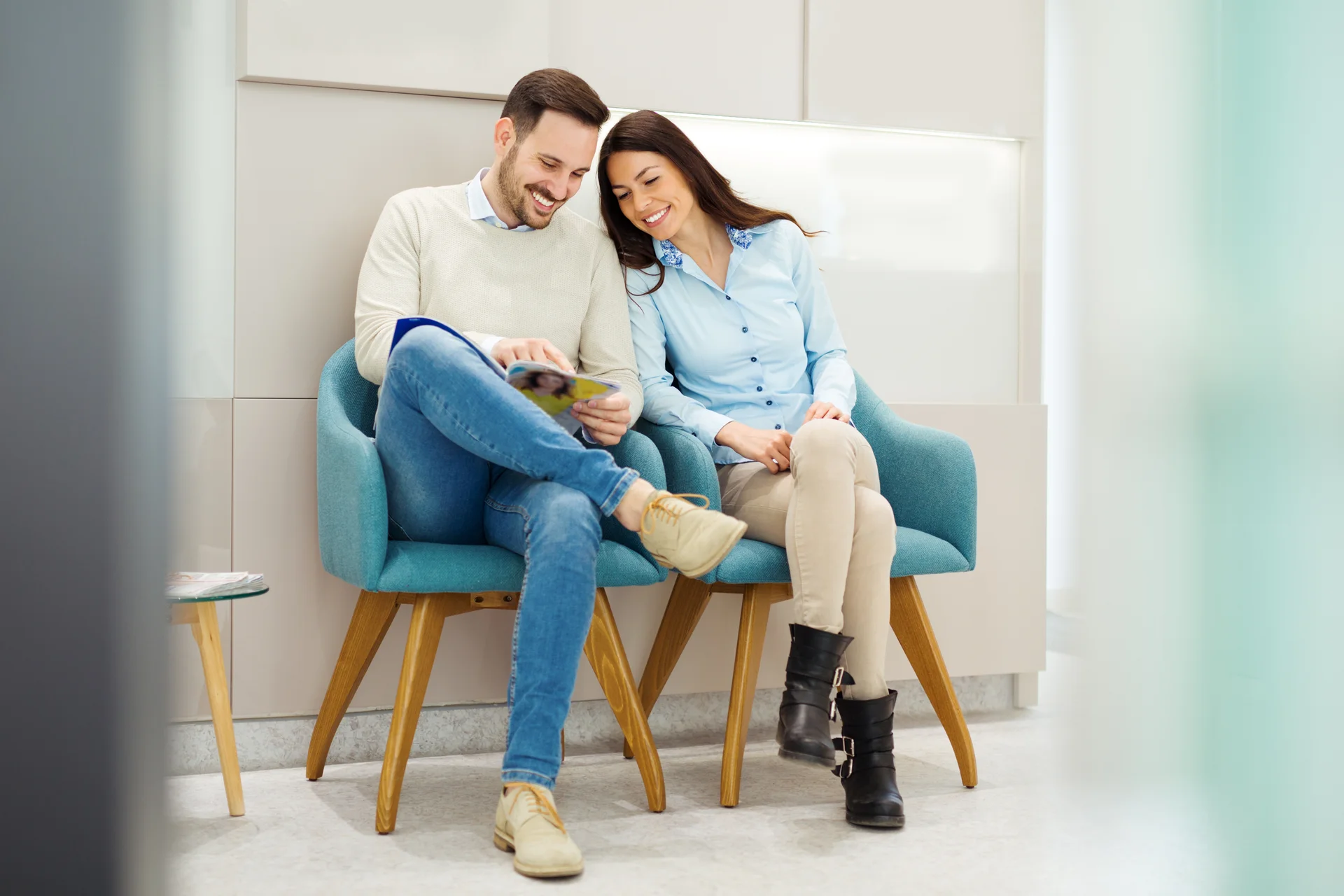 Patient smiling while checking in with a team member at the front desk